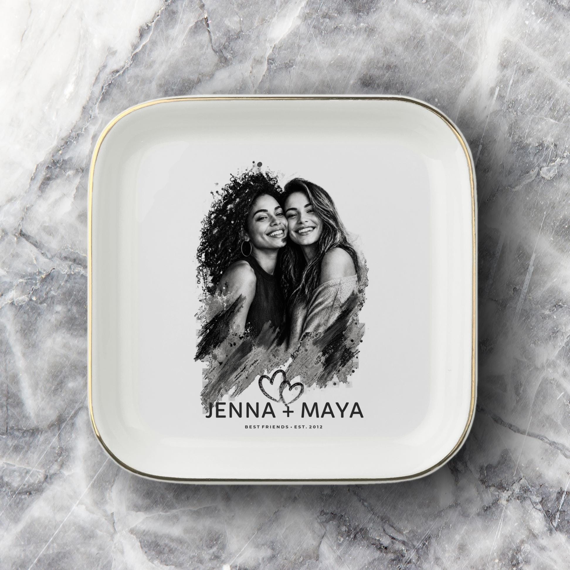 Personalized best friend jewelry dish featuring a custom black-and-white photo, two names, established year, heart design, and gold rim.