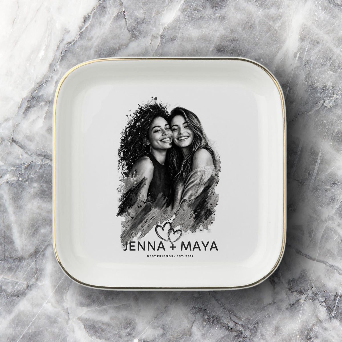 Personalized best friend jewelry dish featuring a custom black-and-white photo, two names, established year, heart design, and gold rim.