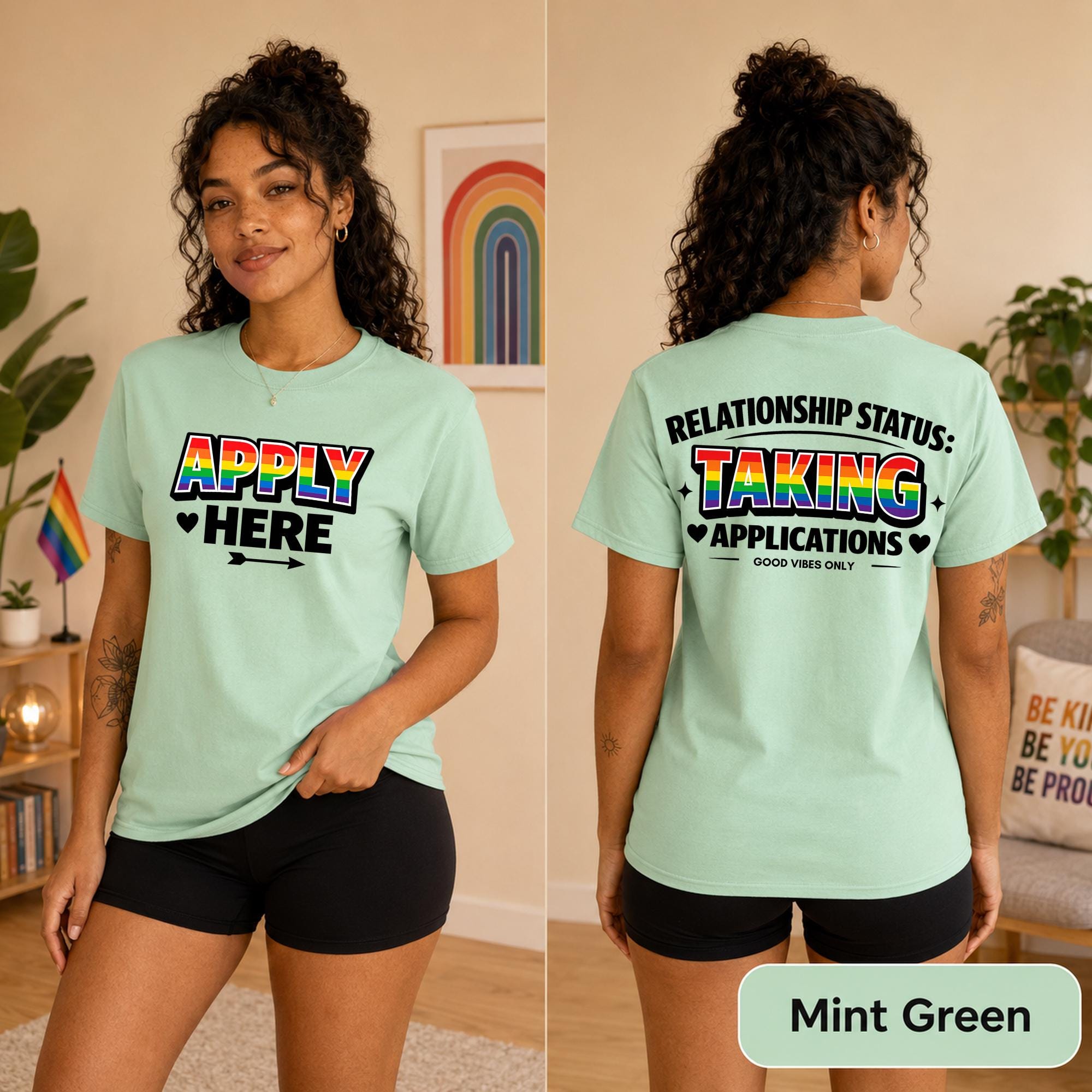 Rainbow relationship status shirt styled with black shorts against a modern concrete background.