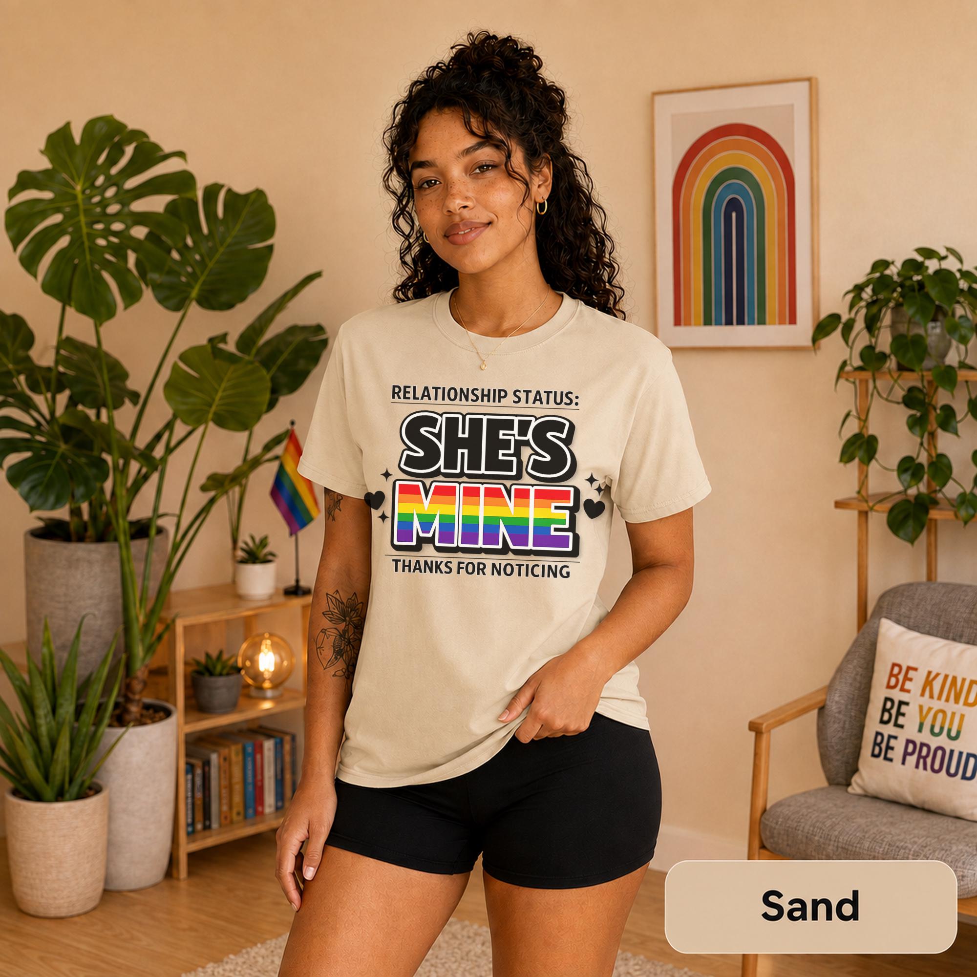 Rainbow couple shirts photographed with plants, Pride flags, and warm neutral decor.
