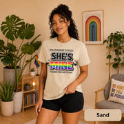Rainbow couple shirts photographed with plants, Pride flags, and warm neutral decor.