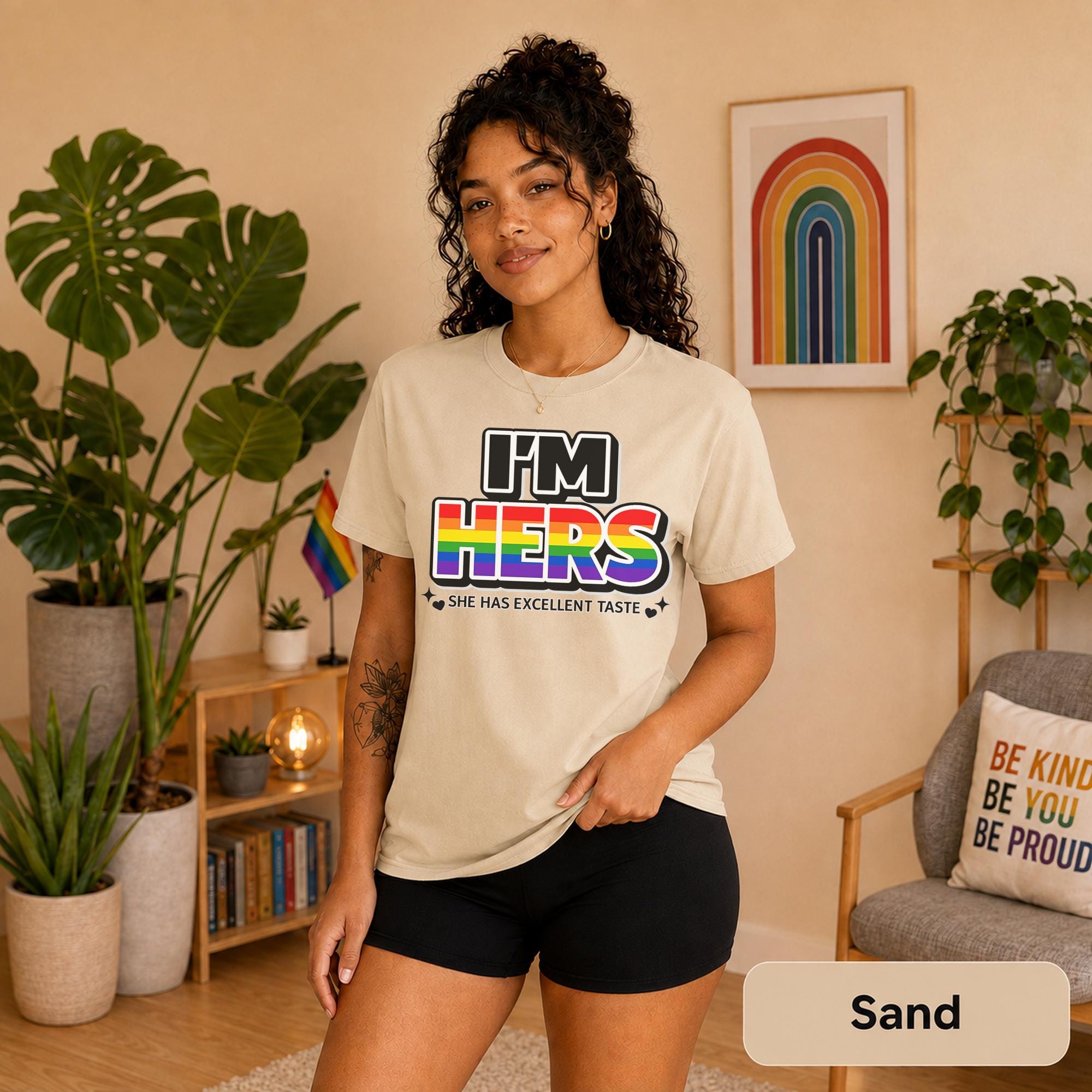 Rainbow couple shirts photographed with plants, Pride flags, and warm neutral decor.