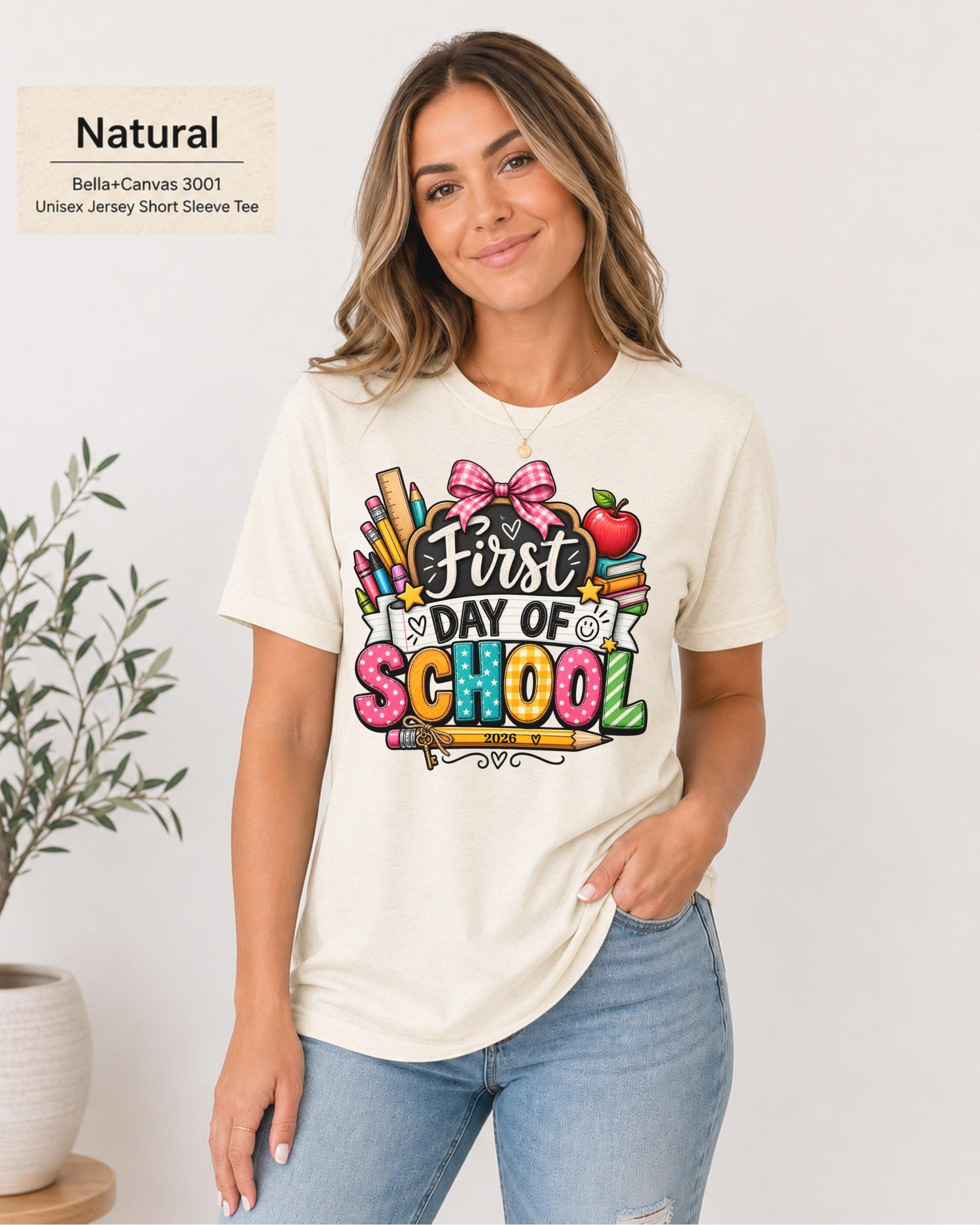Woman wearing an Natural Bella+Canvas 3001 personalized First Day of School shirt with customizable teacher name and year, colorful pencils, crayons, books, apple, and pink bow design.