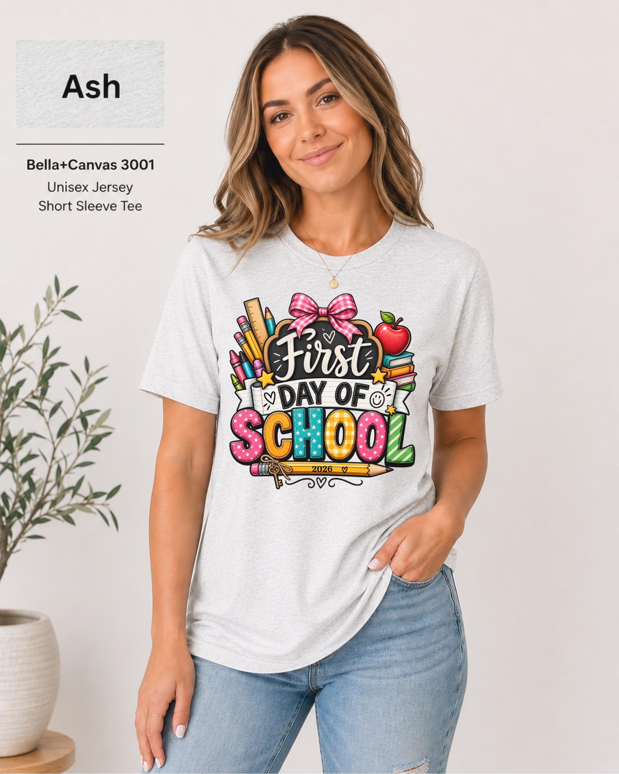 Woman wearing an Ash Bella+Canvas 3001 personalized First Day of School shirt with customizable teacher name and year, colorful pencils, crayons, books, apple, and pink bow design.