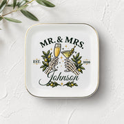 White square jewelry tray with gold rim, personalized Johnson surname, established year, and dark romantic wedding artwork.