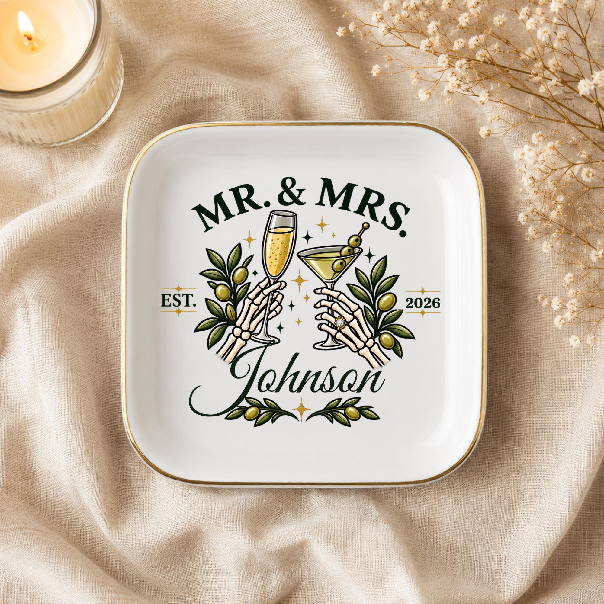 Alternative wedding keepsake dish with skeleton hands toasting, champagne, martini, olives, and custom couple details.