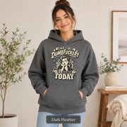 Woman wearing a dark heather Gildan 18500 hoodie with blank front, kangaroo pocket, relaxed unisex fit, and dark heather color label.