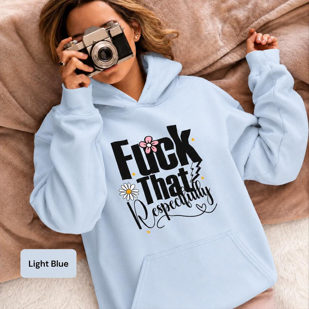 Light blue Gildan 18500 hoodie modeled with a vintage camera, featuring bold “Fuck That Respectfully” lettering and feminine floral details.