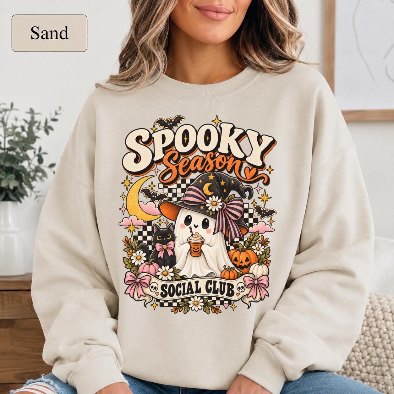 Cute spooky shirt with witch hat ghost, bow-wearing black cat, pumpkins, and daisies.