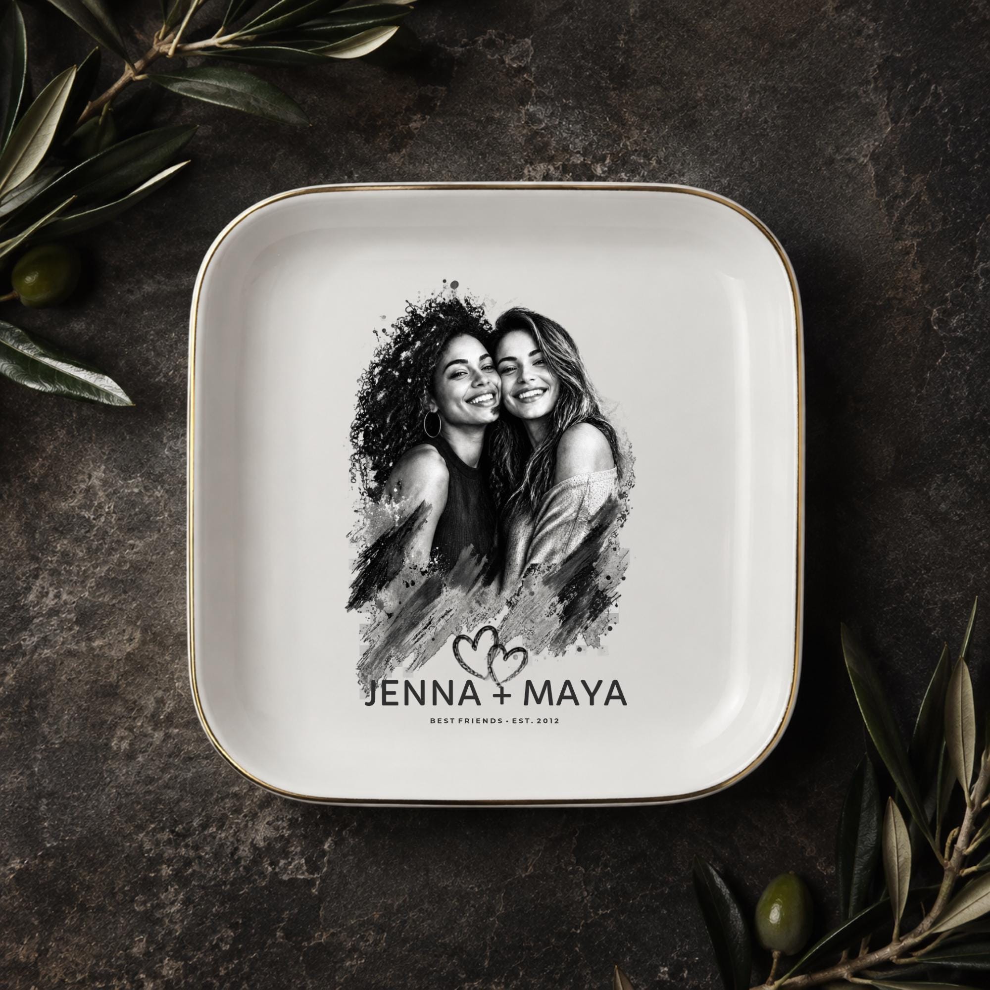 Personalized best friend jewelry dish featuring a custom black-and-white photo, two names, established year, heart design, and gold rim.