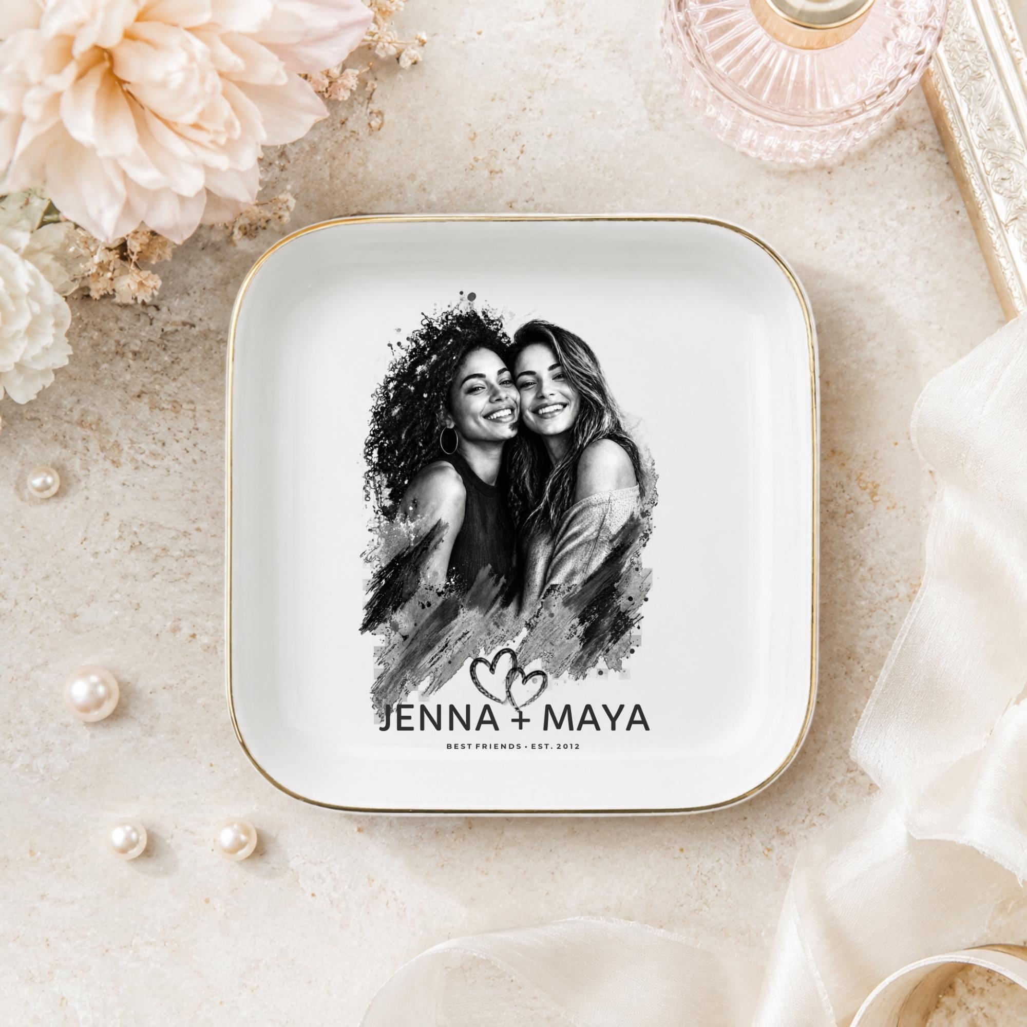 Personalized best friend jewelry dish featuring a custom black-and-white photo, two names, established year, heart design, and gold rim.