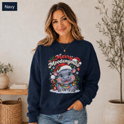 Navy Christmas sweatshirt featuring a cute hippo in a Santa hat with Merry Moodengmas text, candy canes, ornaments, holly, and snowflakes.