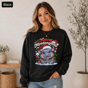 Black Christmas sweatshirt featuring a cute hippo in a Santa hat with Merry Moodengmas text, candy canes, ornaments, holly, and snowflakes.