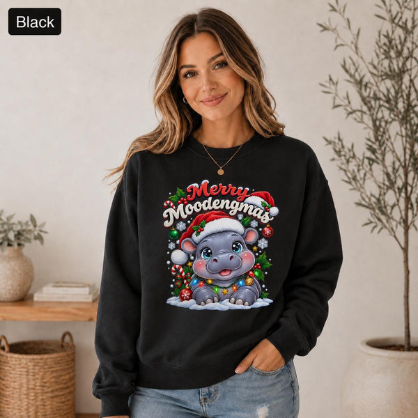 Black Christmas sweatshirt featuring a cute hippo in a Santa hat with Merry Moodengmas text, candy canes, ornaments, holly, and snowflakes.