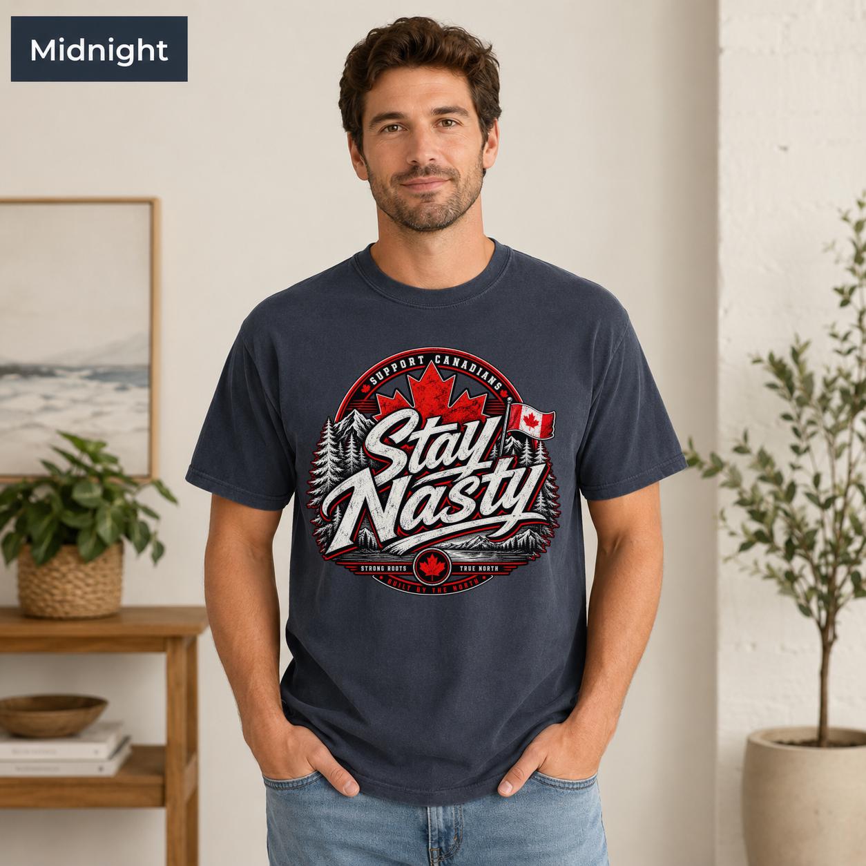 Canadian pride T-shirt with red maple leaf, flag, evergreen trees, mountains, and bold Stay Nasty lettering.
