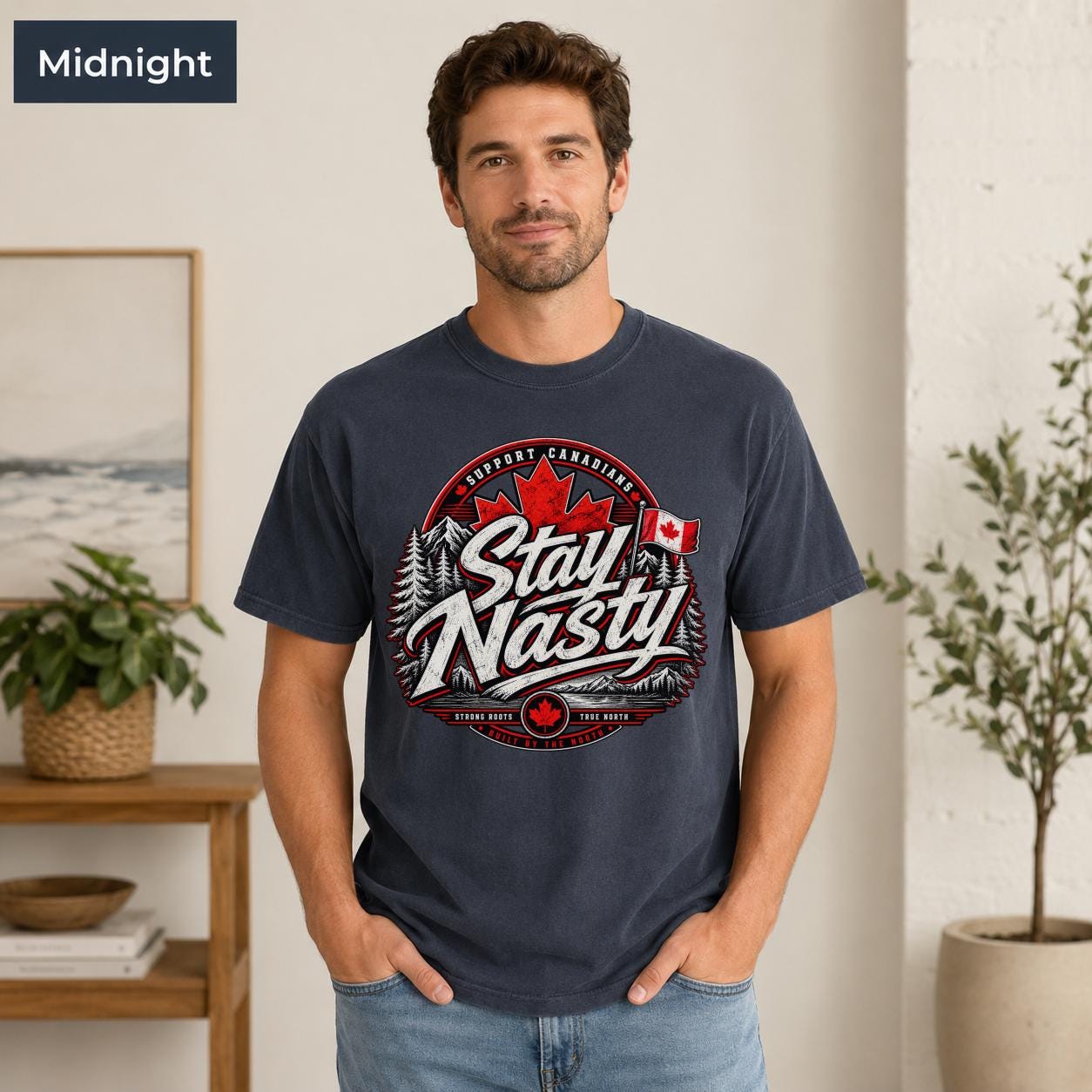 Canadian pride T-shirt with red maple leaf, flag, evergreen trees, mountains, and bold Stay Nasty lettering.