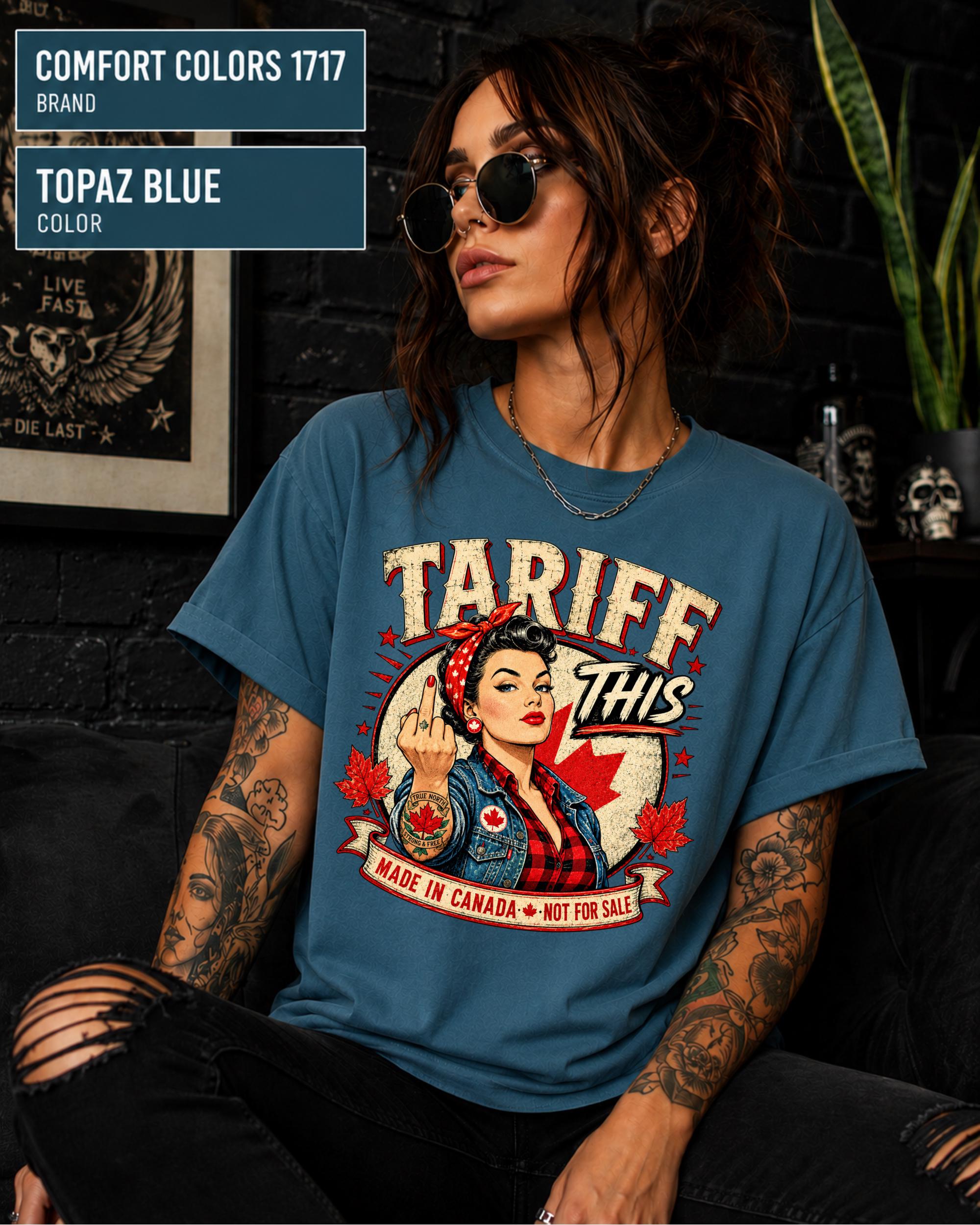 Woman wearing a Topaz Blue Comfort Colors 1717 shirt with Tariff This text, Canadian flag, maple leaves, and retro pin-up artwork.