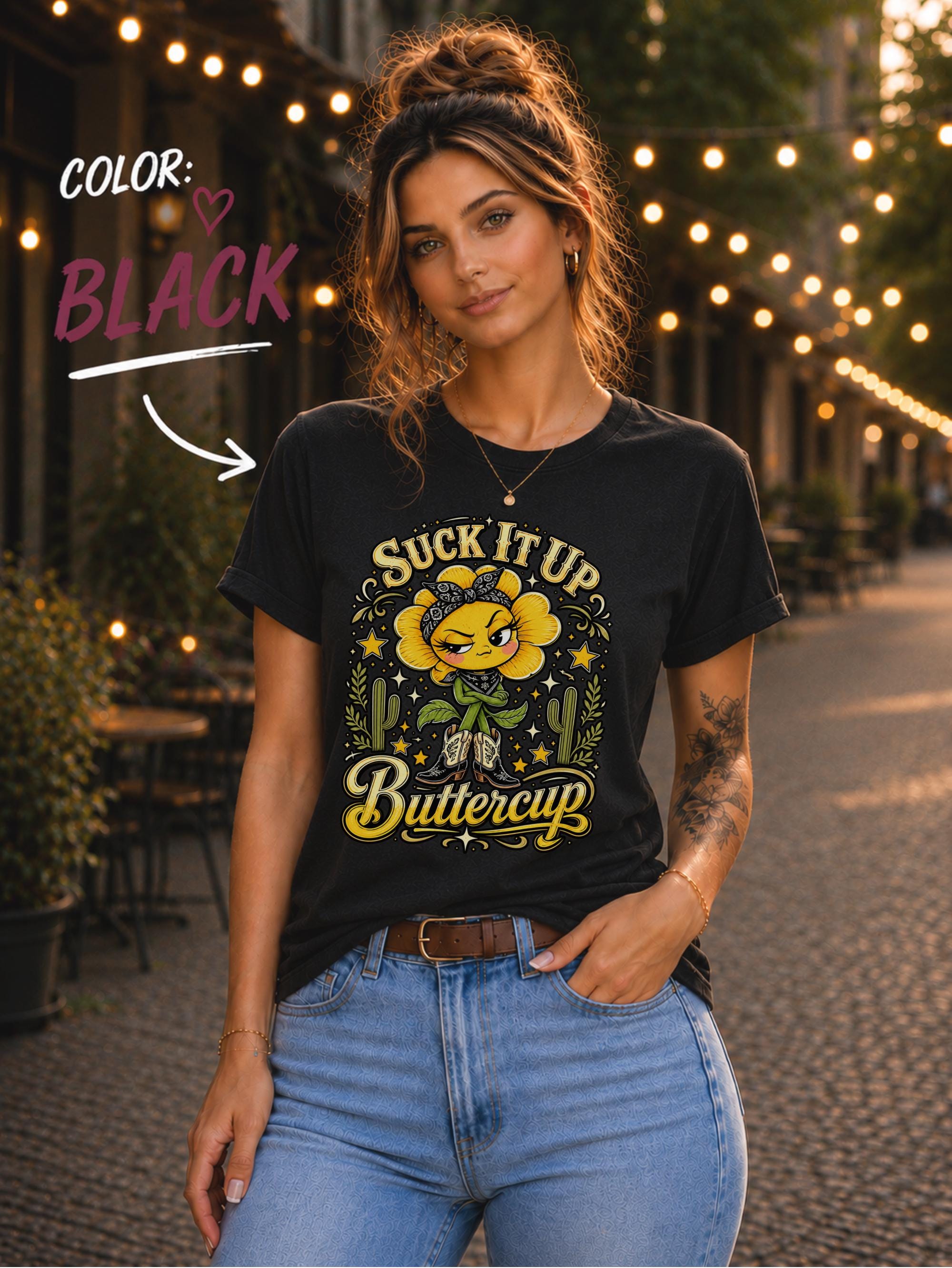 Woman wearing a black Suck It Up Buttercup shirt featuring a yellow western flower in cowboy boots.
