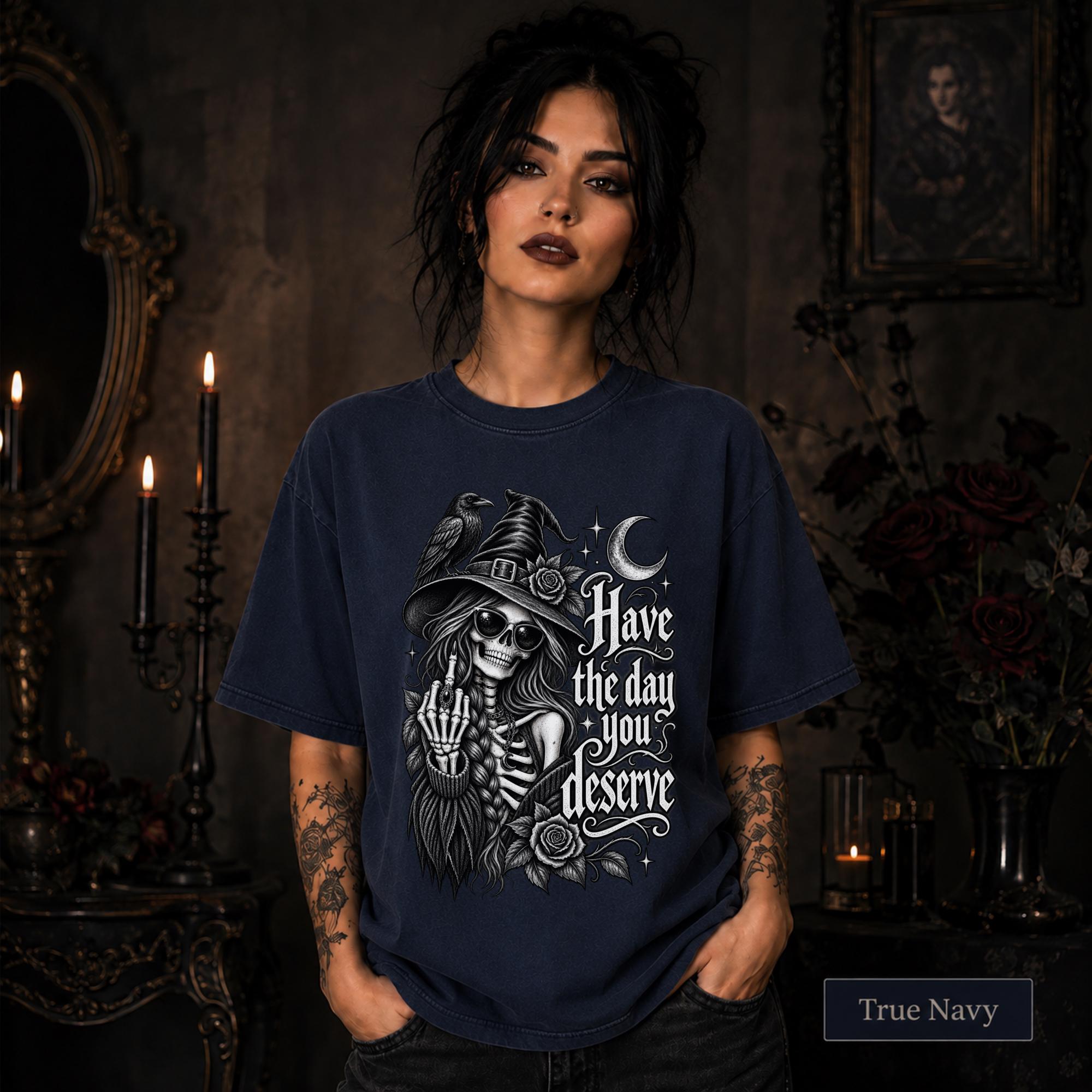 Witchy clothing design with skeletal woman wearing sunglasses and pointed hat beside a raven.