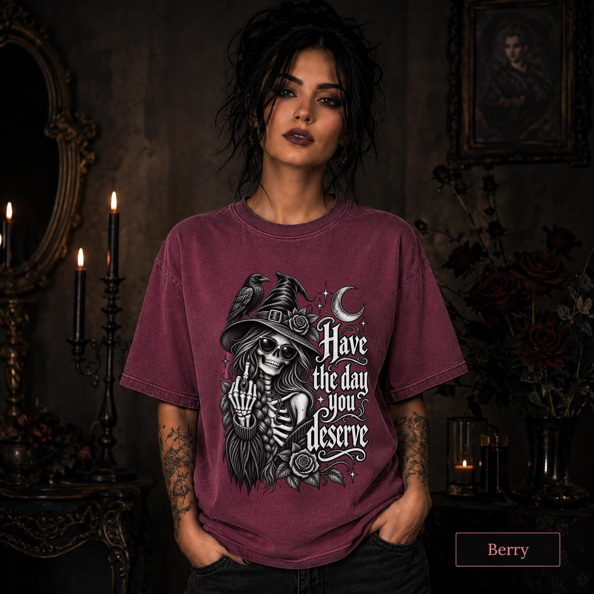 Dark humor women’s tee with skeleton witch, black raven, roses, stars, and crescent moon illustration.