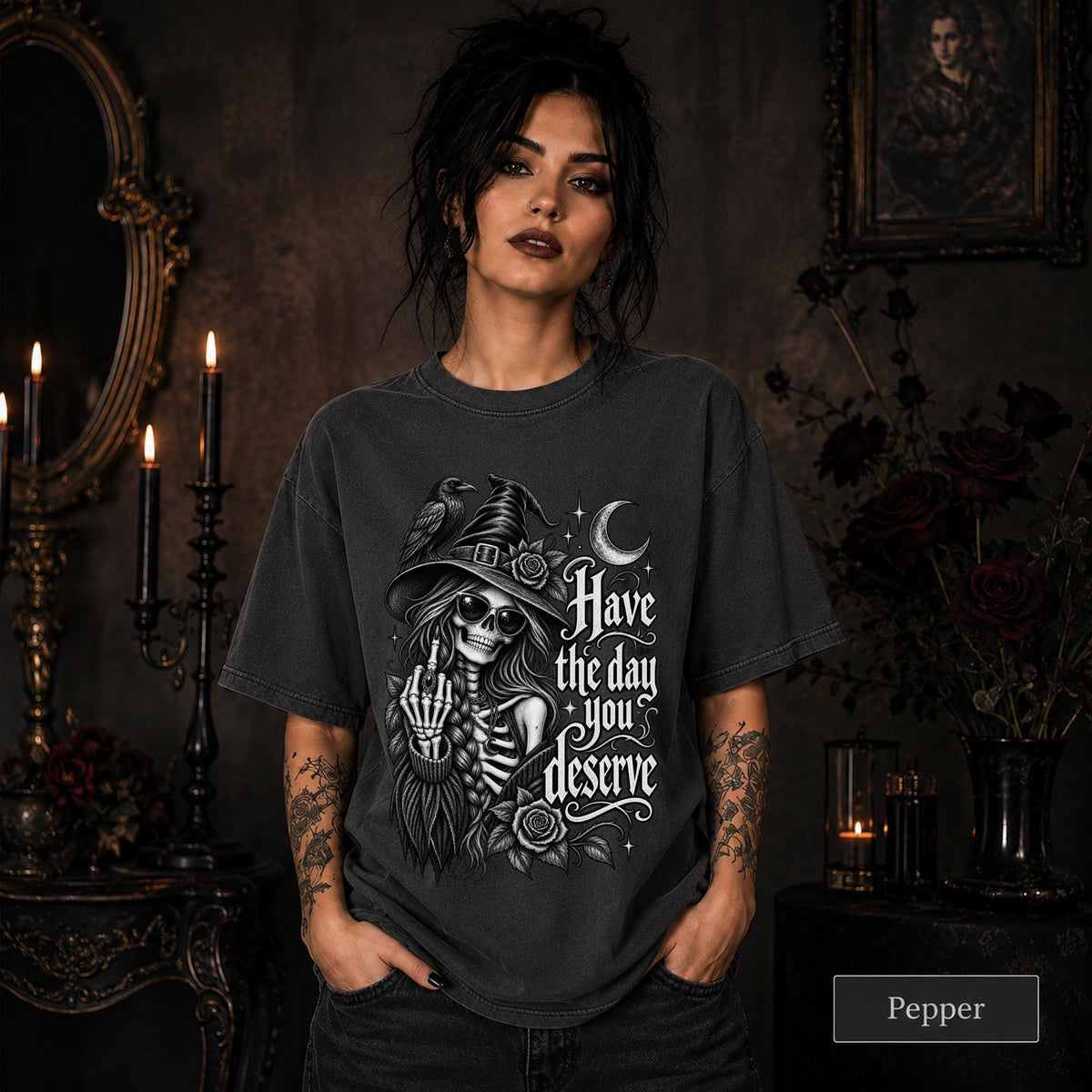 Witchy clothing design with skeletal woman wearing sunglasses and pointed hat beside a raven.
