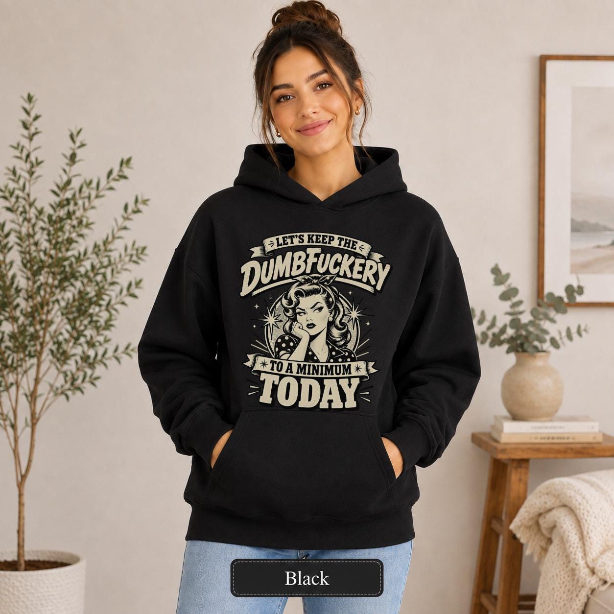 Retro sarcastic graphic reading “Let’s Keep the Dumbfuckery to a Minimum Today” with a vintage pin-up woman, bold distressed lettering, and cream black ink styling.