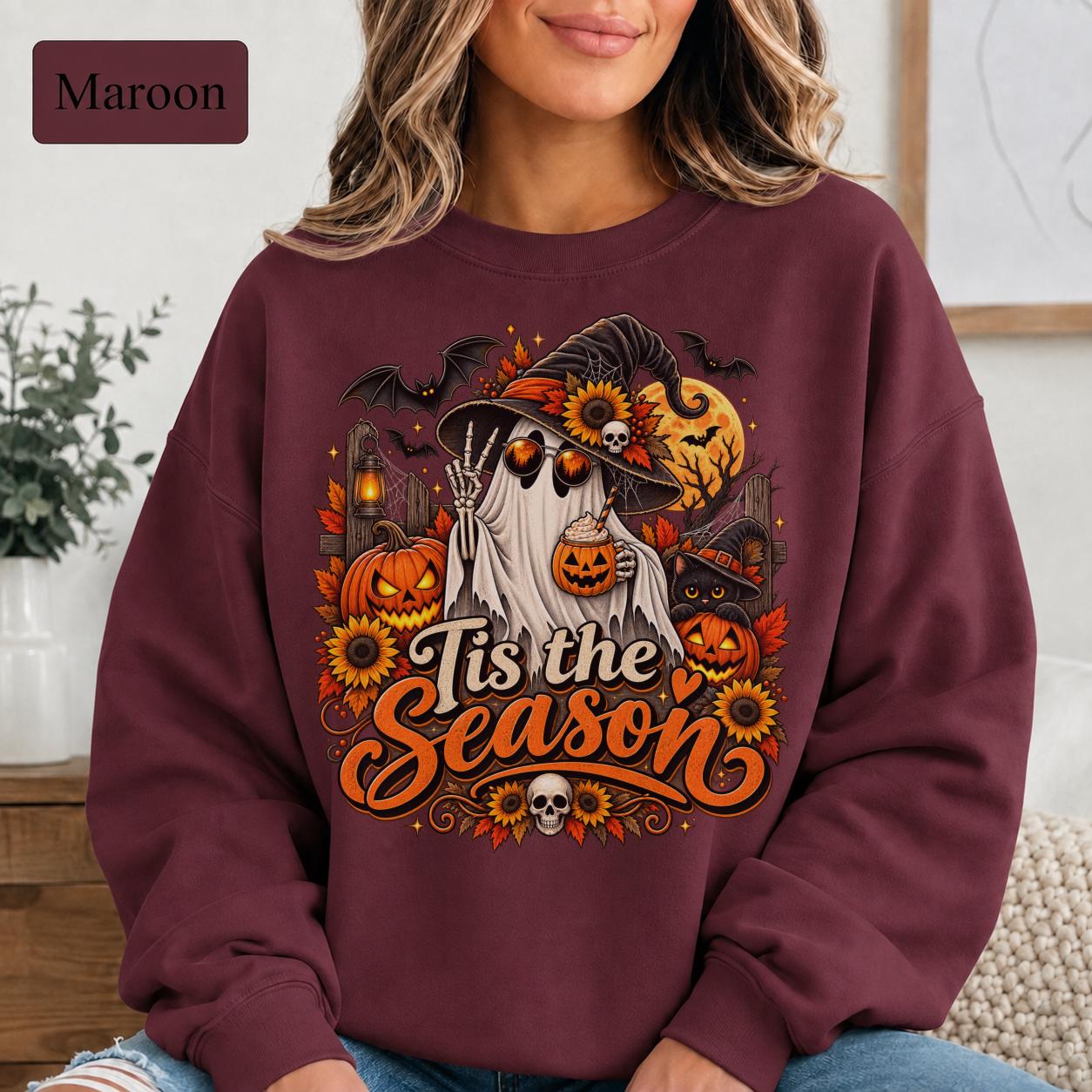 Maroon spooky season crewneck featuring a ghost in a witch hat holding a pumpkin drink beside jack-o-lanterns.