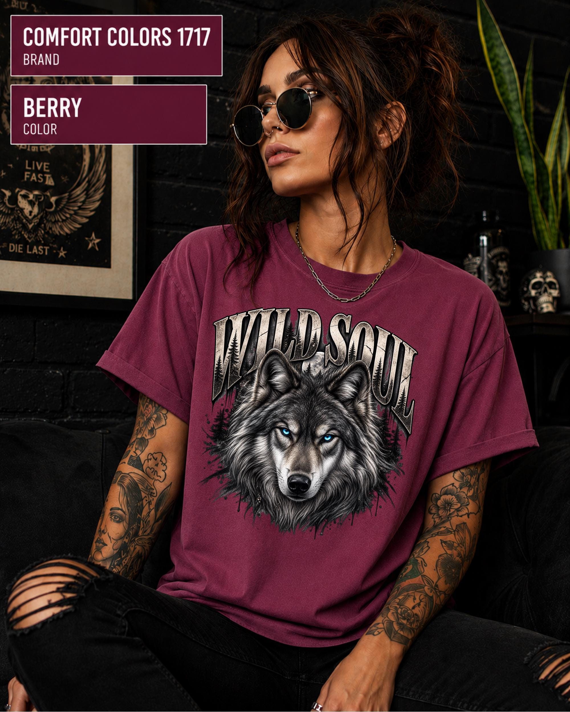 Wild Soul wolf graphic Comfort Colors 1717 T-shirt in berry featuring a detailed gray wolf with bright blue eyes and forest-inspired artwork.