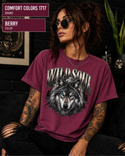 Wild Soul wolf graphic Comfort Colors 1717 T-shirt in berry featuring a detailed gray wolf with bright blue eyes and forest-inspired artwork.