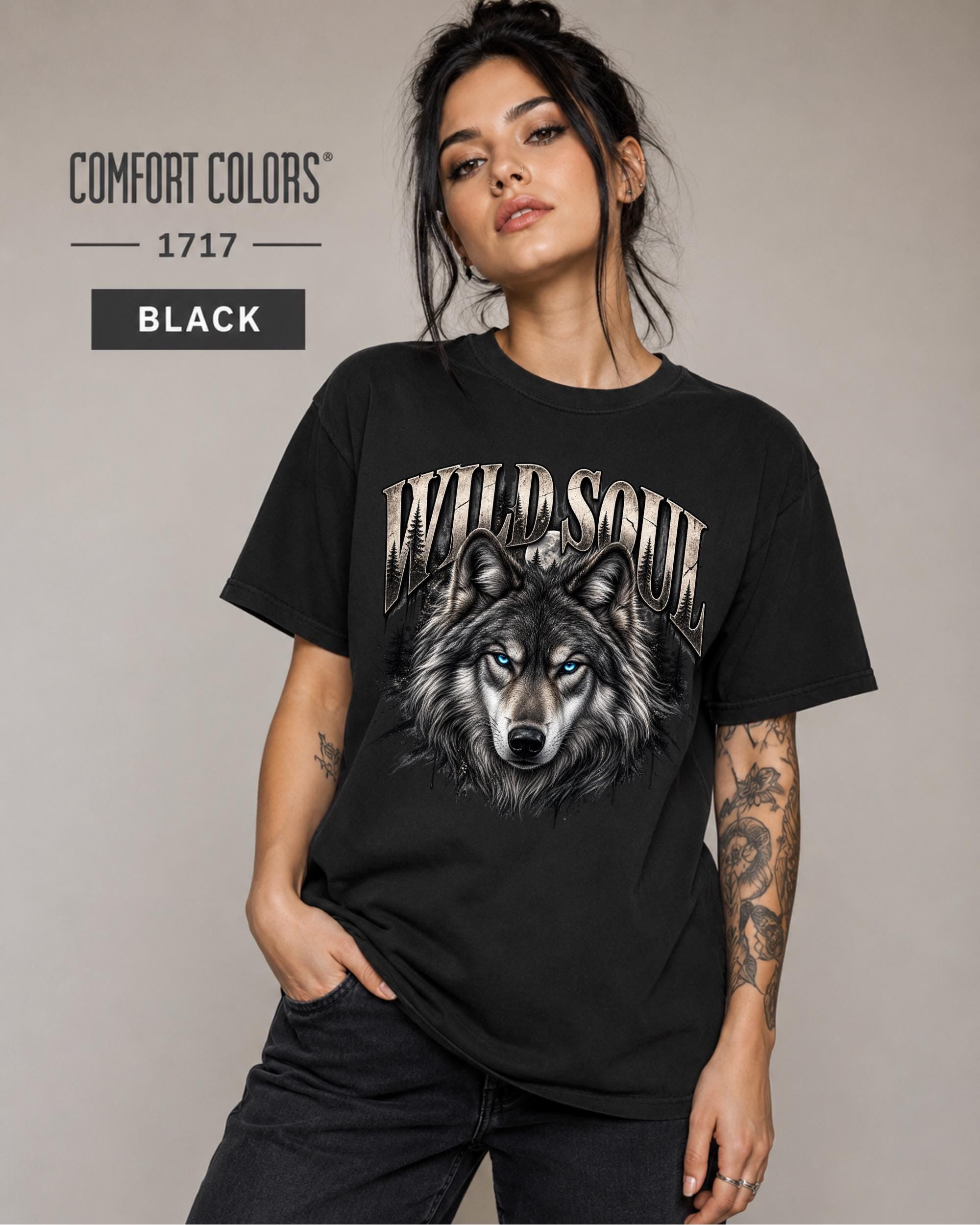 Wild Soul wolf graphic Comfort Colors 1717 T-shirt in black featuring a detailed gray wolf with bright blue eyes and forest-inspired artwork.