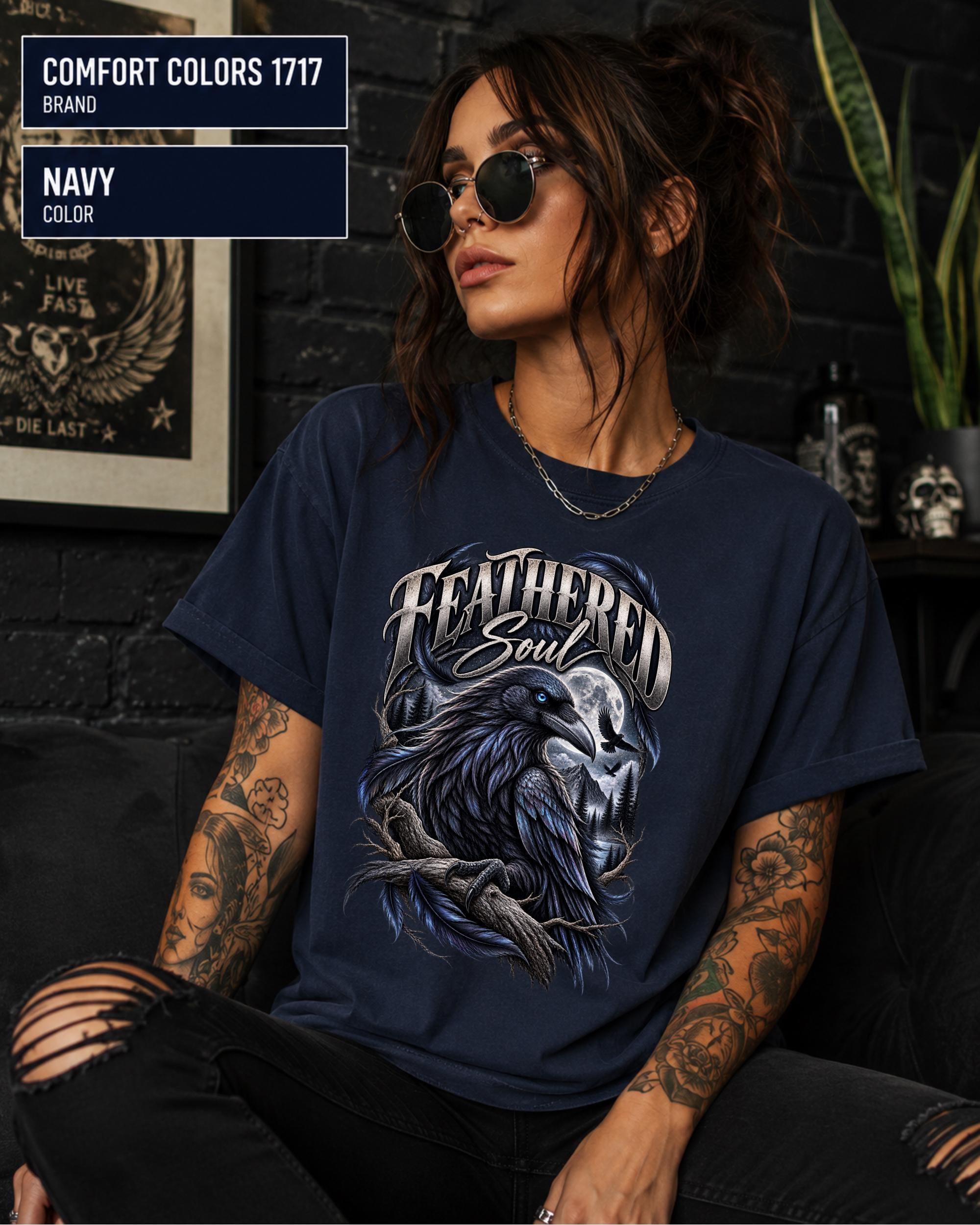 Feathered Soul raven graphic Comfort Colors 1717 T-shirt in navy featuring a detailed black raven with a blue eye, moonlit forest, branches, and gothic artwork.