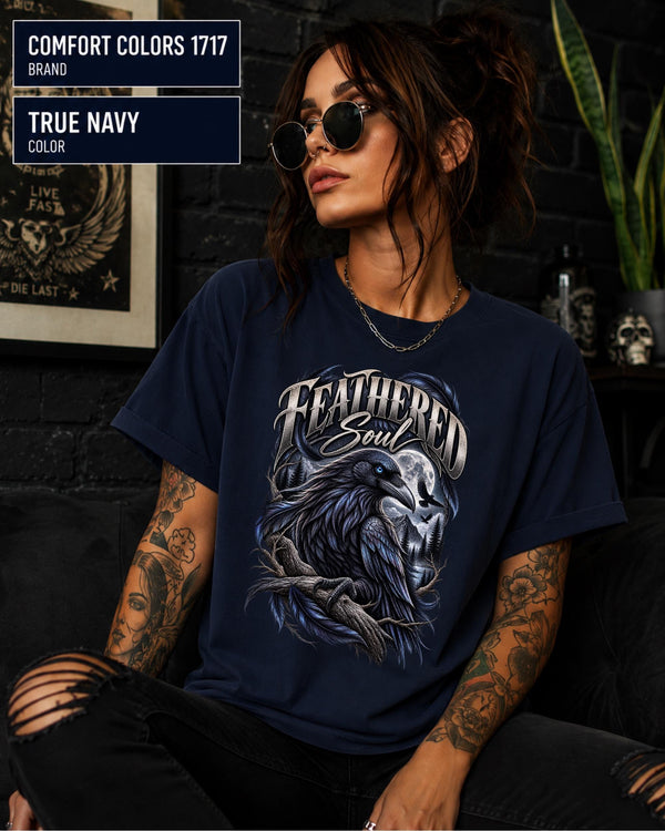 Feathered Soul raven graphic Comfort Colors 1717 T-shirt in true navy featuring a detailed black raven with a blue eye, moonlit forest, branches, and gothic artwork.