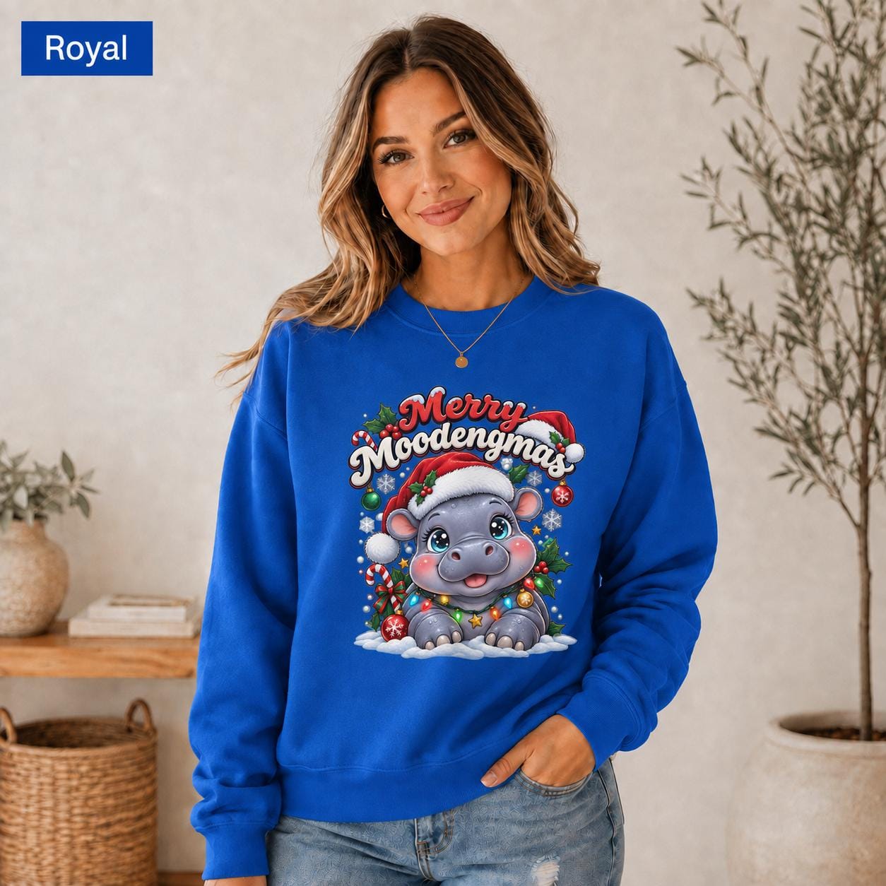 Royal Christmas sweatshirt featuring a cute hippo in a Santa hat with Merry Moodengmas text, candy canes, ornaments, holly, and snowflakes.