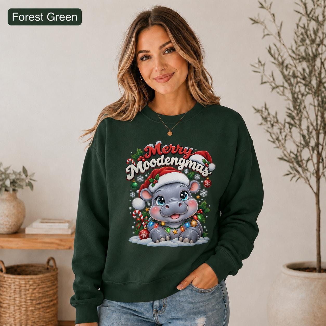 Forest green Christmas sweatshirt featuring a cute hippo in a Santa hat with Merry Moodengmas text, candy canes, ornaments, holly, and snowflakes.