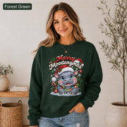 Forest green Christmas sweatshirt featuring a cute hippo in a Santa hat with Merry Moodengmas text, candy canes, ornaments, holly, and snowflakes.