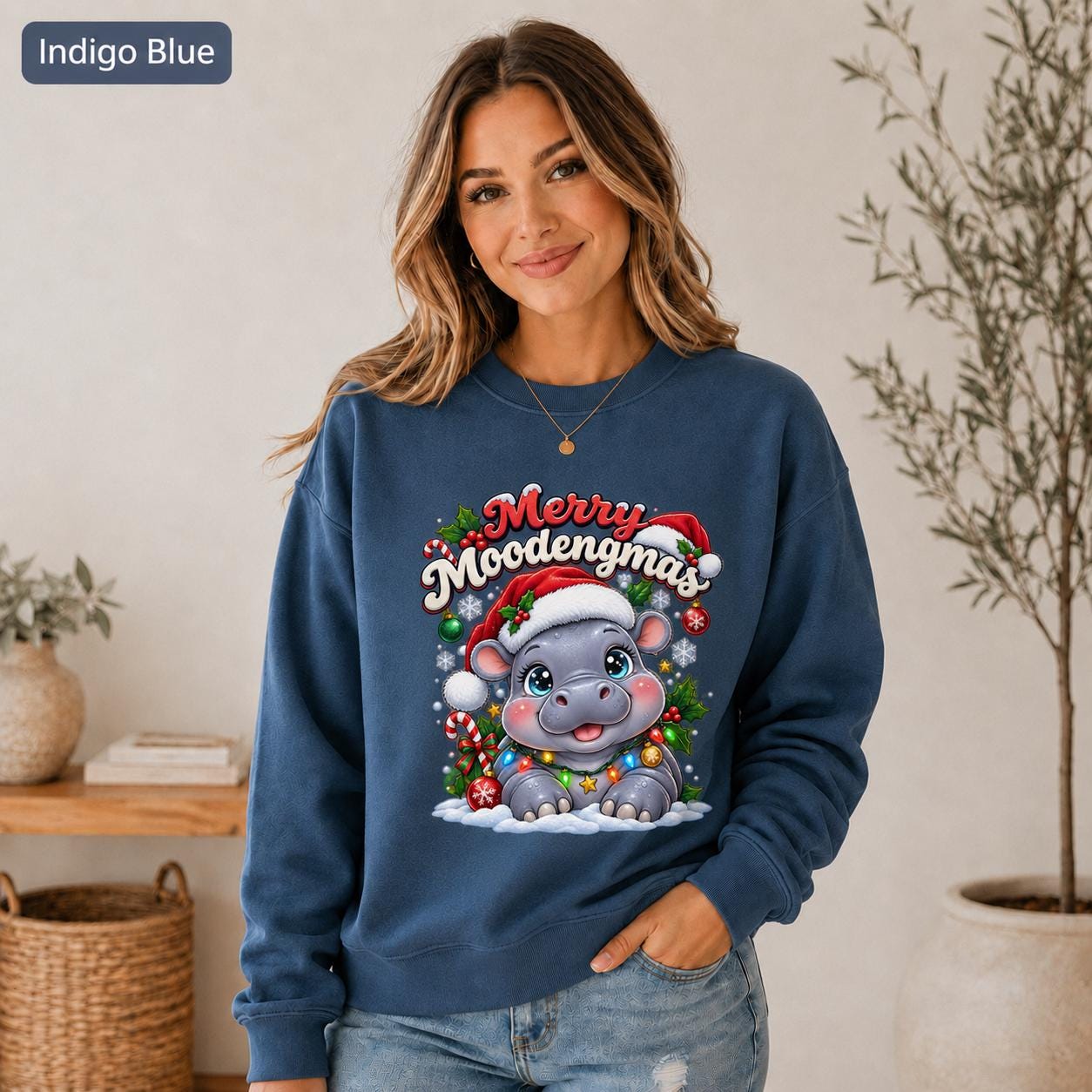 Indigo Blue Christmas sweatshirt featuring a cute hippo in a Santa hat with Merry Moodengmas text, candy canes, ornaments, holly, and snowflakes.