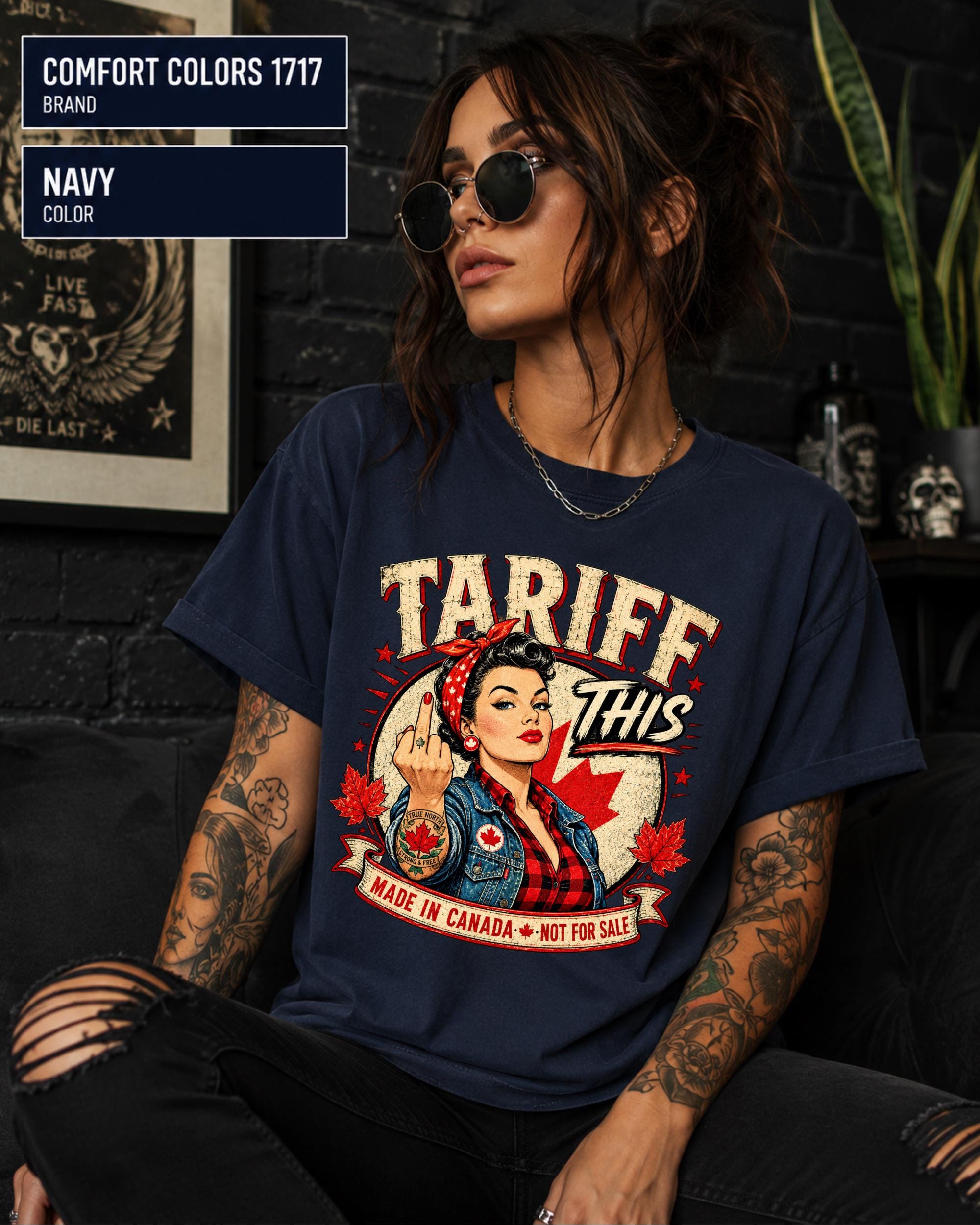 Woman wearing a Navy Comfort Colors 1717 shirt with Tariff This text, Canadian flag, maple leaves, and retro pin-up artwork.