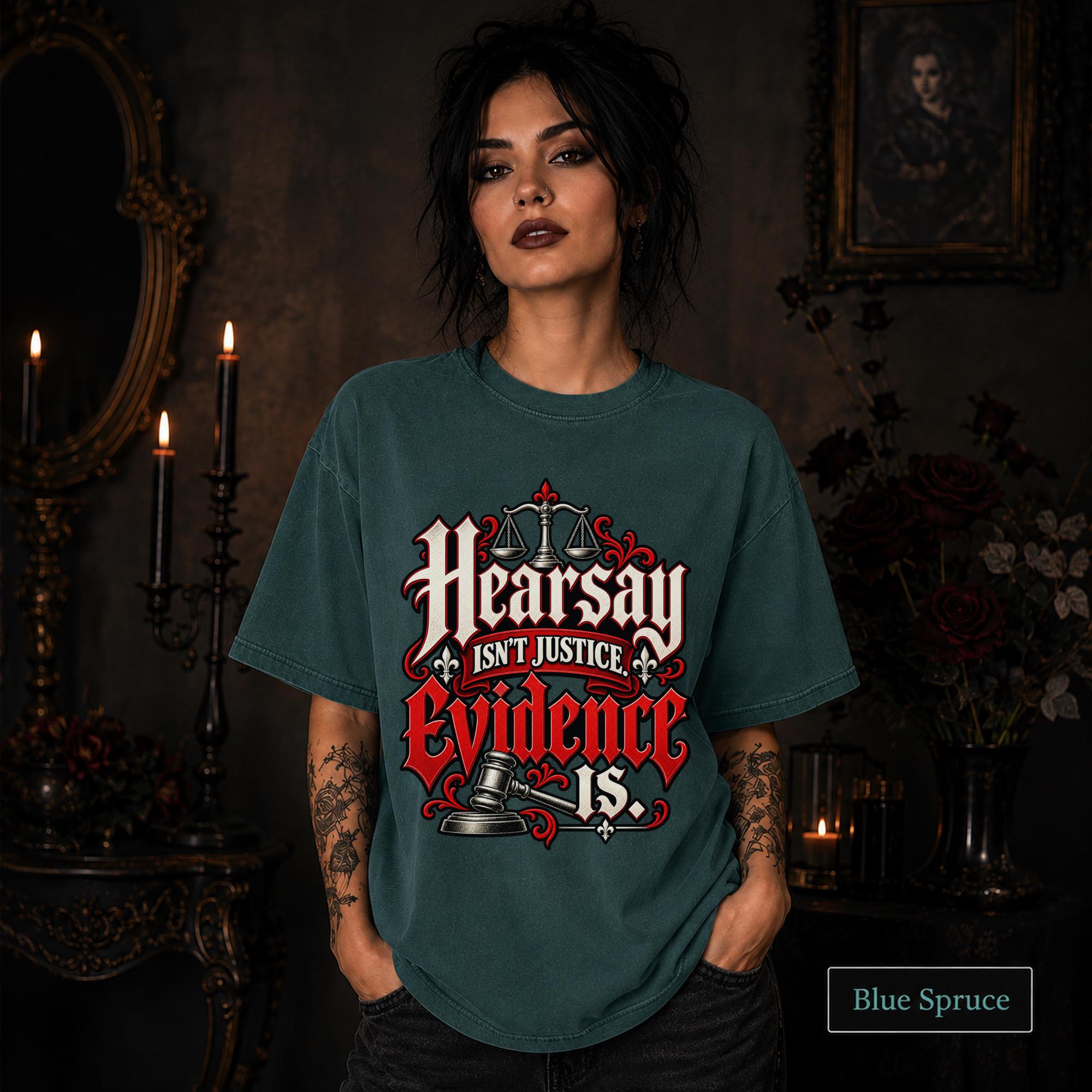 Hearsay Isn’t Justice Evidence Is blue spruce T-shirt featuring red and white gothic lettering, scales of justice, and a judge’s gavel.