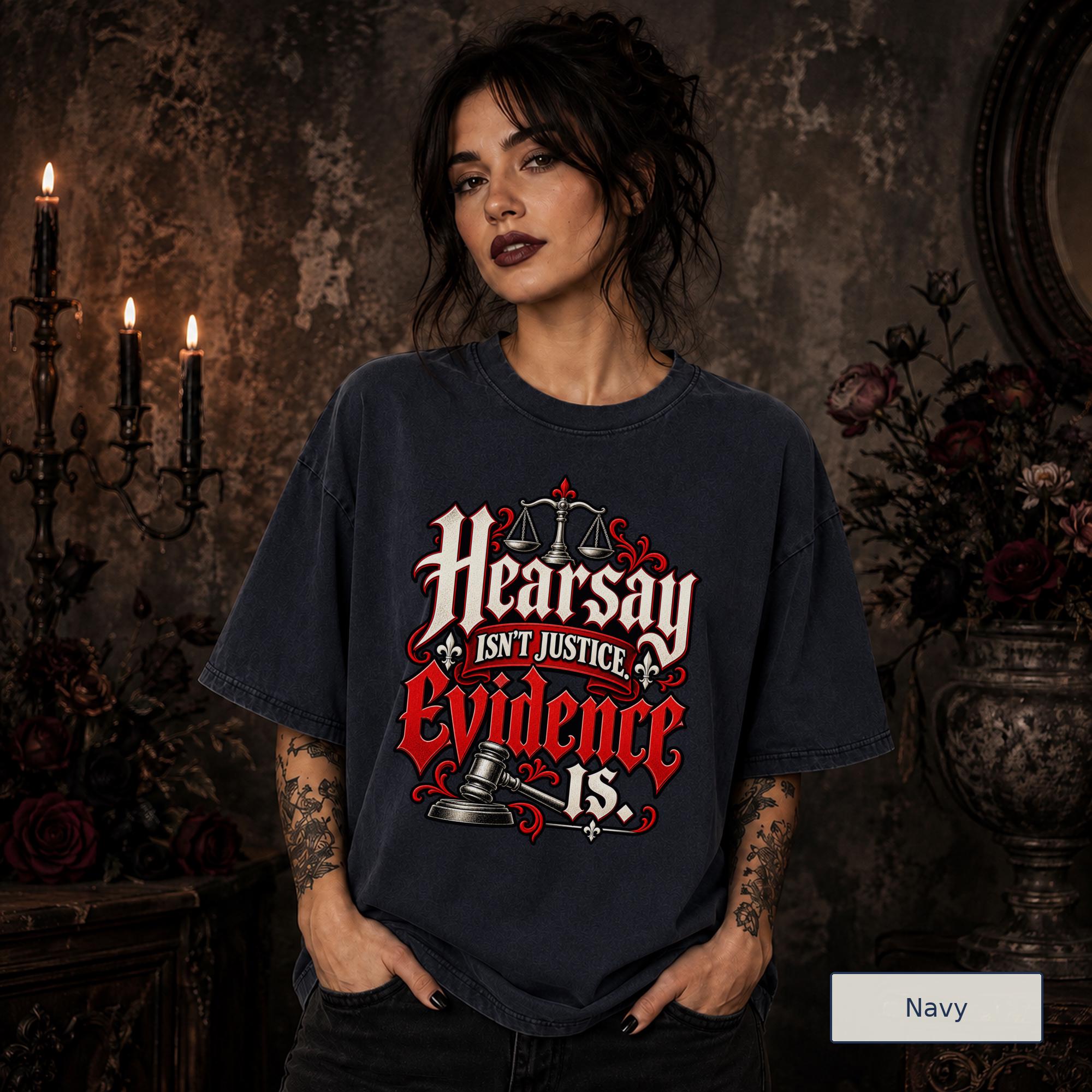 Hearsay Isn’t Justice Evidence Is navy T-shirt featuring red and white gothic lettering, scales of justice, and a judge’s gavel.