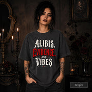 Alibis Evidence and Vibes graphic T-shirt in pepper featuring bold red and white gothic lettering on a dark unisex tee.
