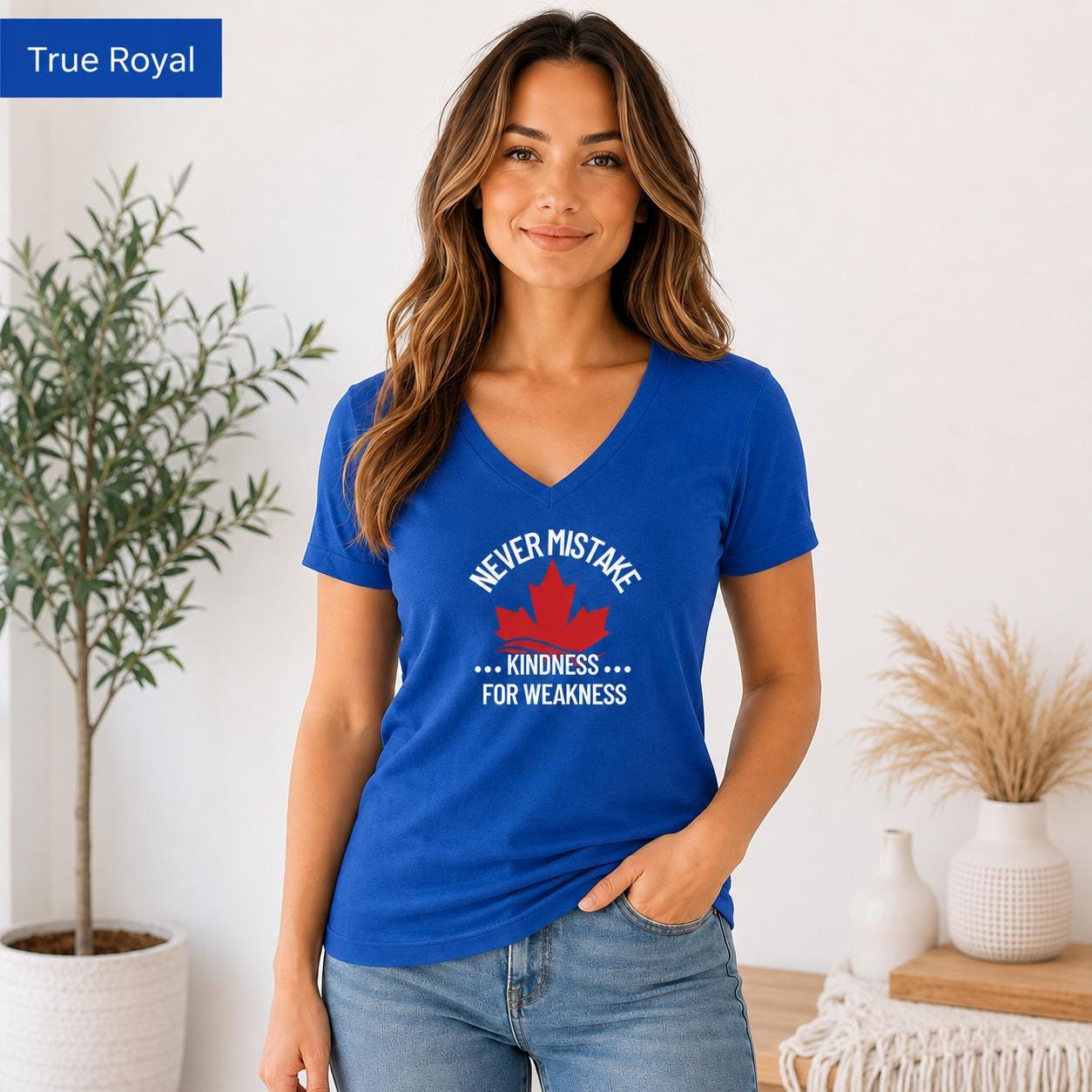 True royal blue Bella Canvas 3005 V-neck T-shirt mockup featuring red maple leaf and Never Mistake Kindness for Weakness text.