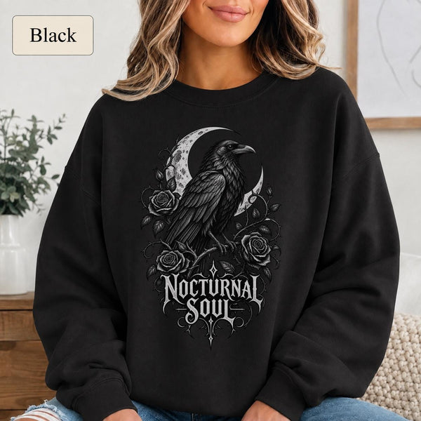 Woman wearing a blackl crewneck sweatshirt featuring a detailed black raven surrounded by a crescent moon, thorny roses, and Nocturnal Soul lettering.