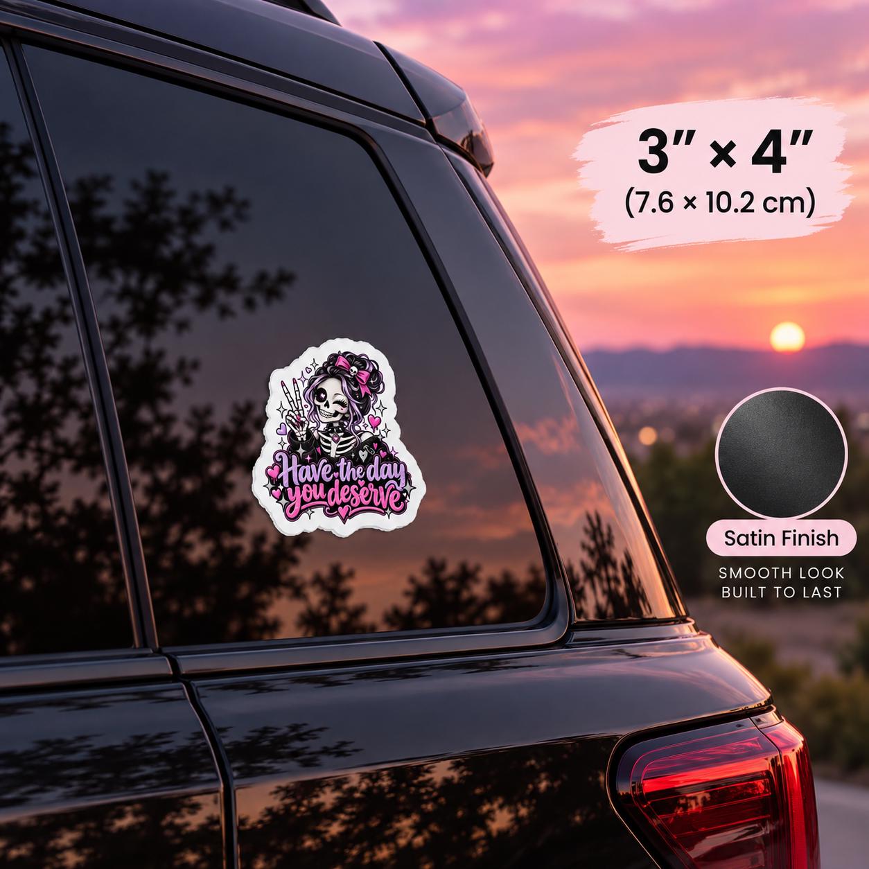 3x4 inch satin finish vinyl car decal mockup featuring a pink and purple skeleton girl with “Have the Day You Deserve” text on a vehicle window.