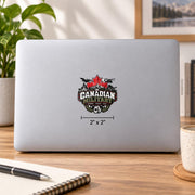 2x2 inch Canadian Military UV DTF sticker mockup on a silver laptop featuring a red maple leaf, military aircraft, ship, tank, mountains, and “Strong Proud True” text.
