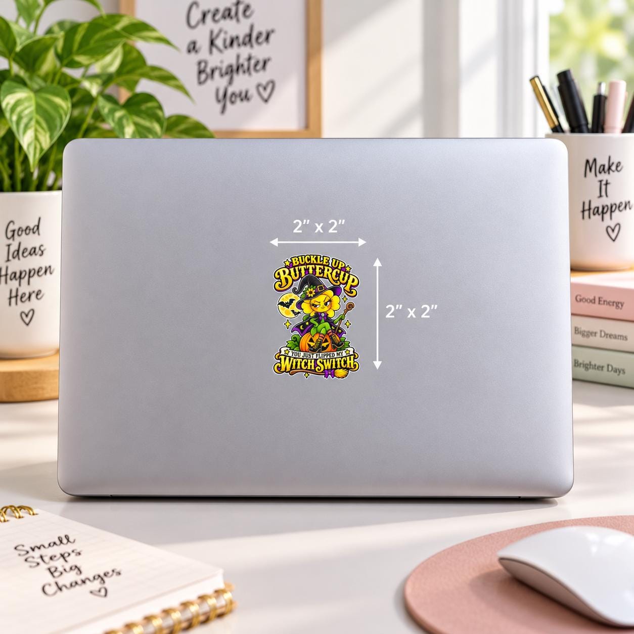 2x2 inch Buckle Up Buttercup UV DTF sticker mockup on a silver laptop featuring a cute witchy flower, pumpkin, bats, and Witch Switch text.
