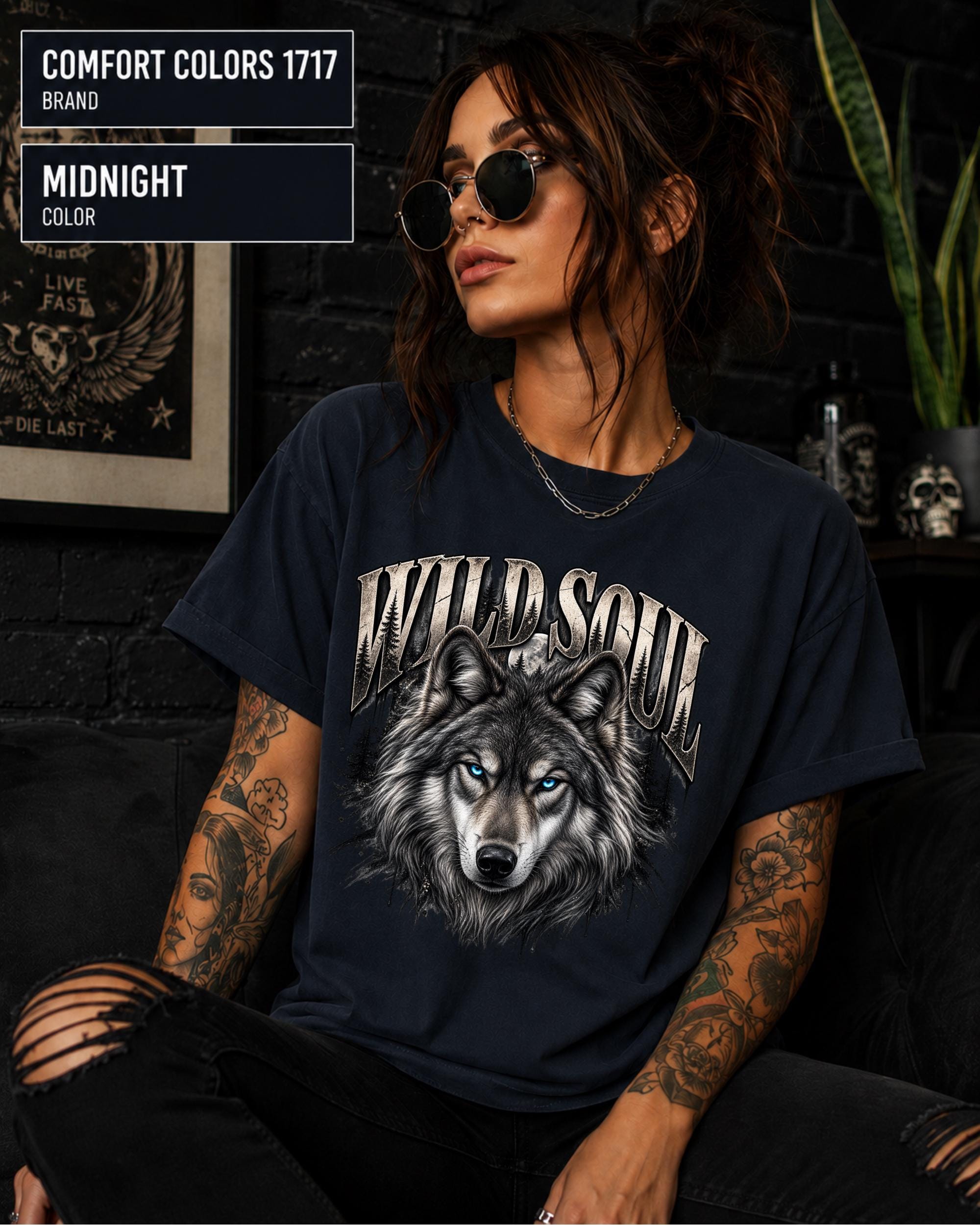 Wild Soul wolf graphic Comfort Colors 1717 T-shirt in midnight featuring a detailed gray wolf with bright blue eyes and forest-inspired artwork.
