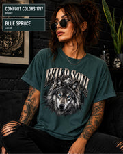 Wild Soul wolf graphic Comfort Colors 1717 T-shirt in blue spruce featuring a detailed gray wolf with bright blue eyes and forest-inspired artwork.