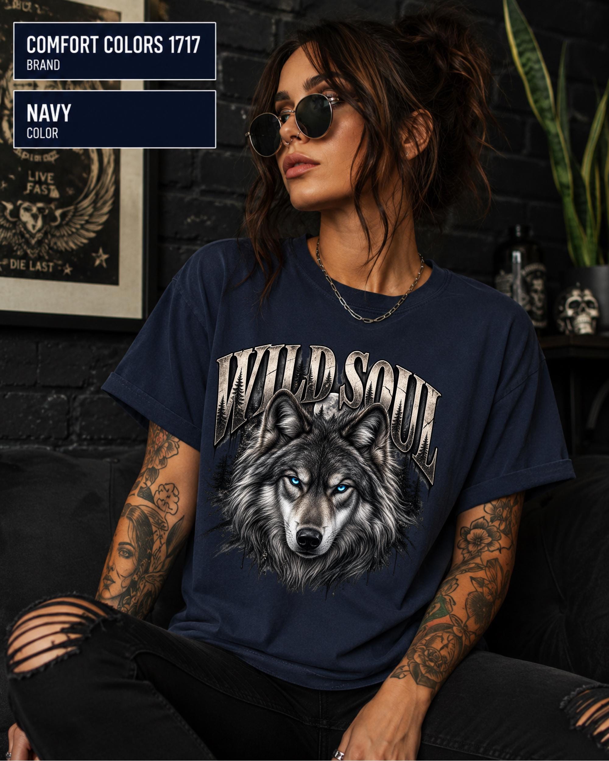 Wild Soul wolf graphic Comfort Colors 1717 T-shirt in navy featuring a detailed gray wolf with bright blue eyes and forest-inspired artwork.