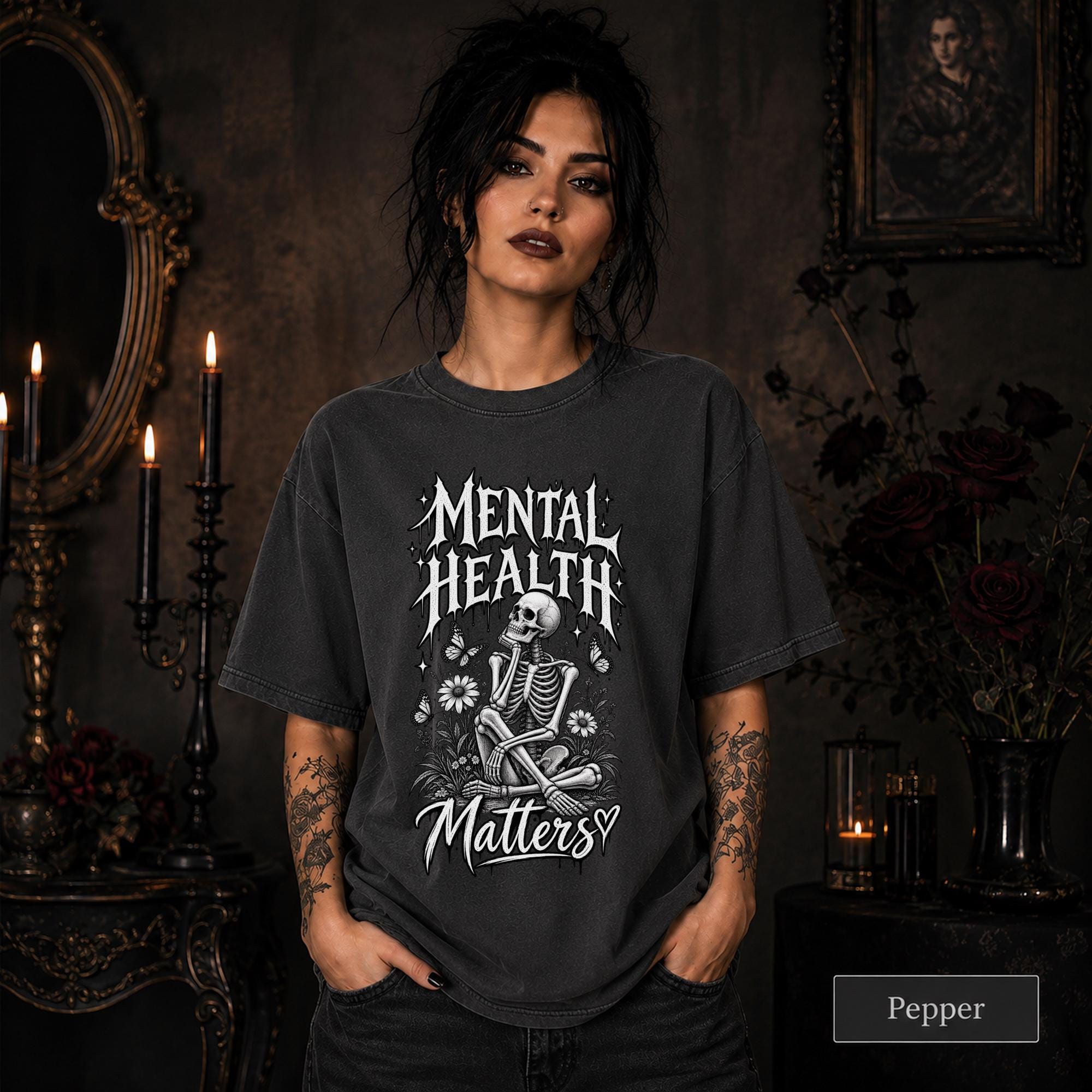 Mental Health Matters pepper T-shirt featuring a seated skeleton, flowers, butterflies, and bold gothic lettering in a monochrome design.