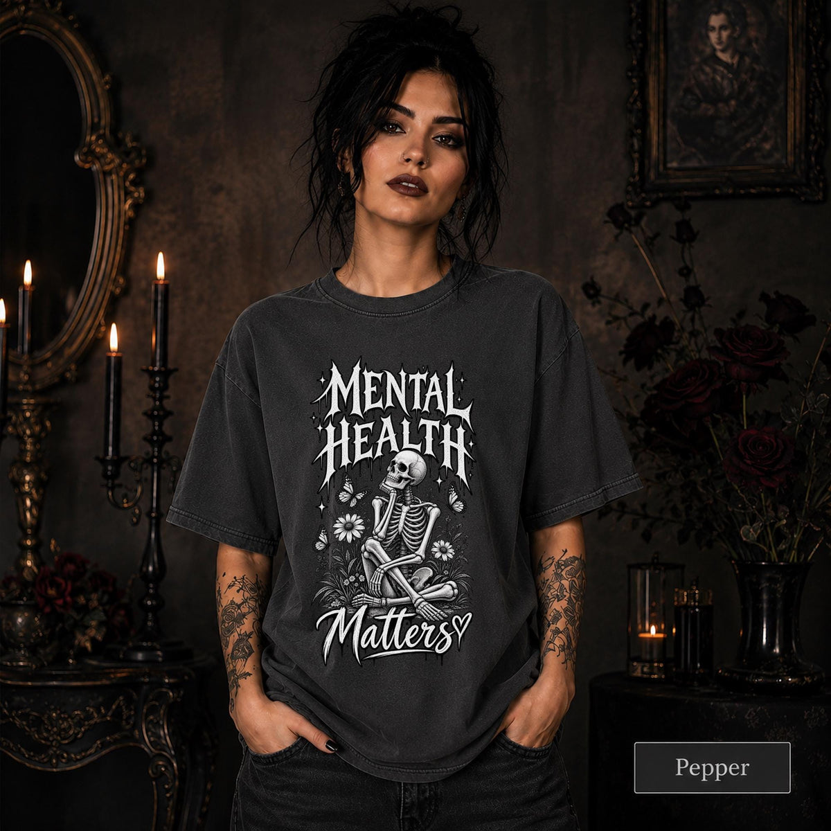 Mental Health Matters pepper T-shirt featuring a seated skeleton, flowers, butterflies, and bold gothic lettering in a monochrome design.
